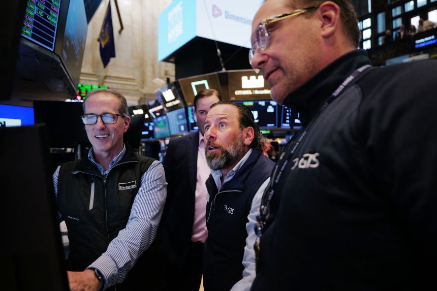 Traders work on the floor of the New York Stock Exchange on Tuesday in New York City. The Dow rose more than 1,000 points in trading on hopes that tensions with Iran are easing and that oil prices will begin to fall.