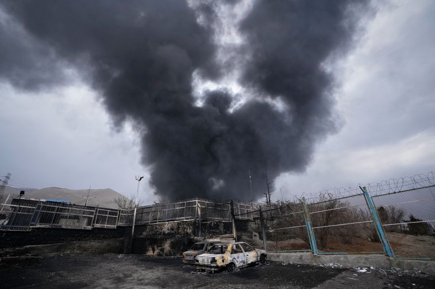 Thick smoke rises from an oil depot hit by a US-Israeli strike in Tehran, Iran, March 8.