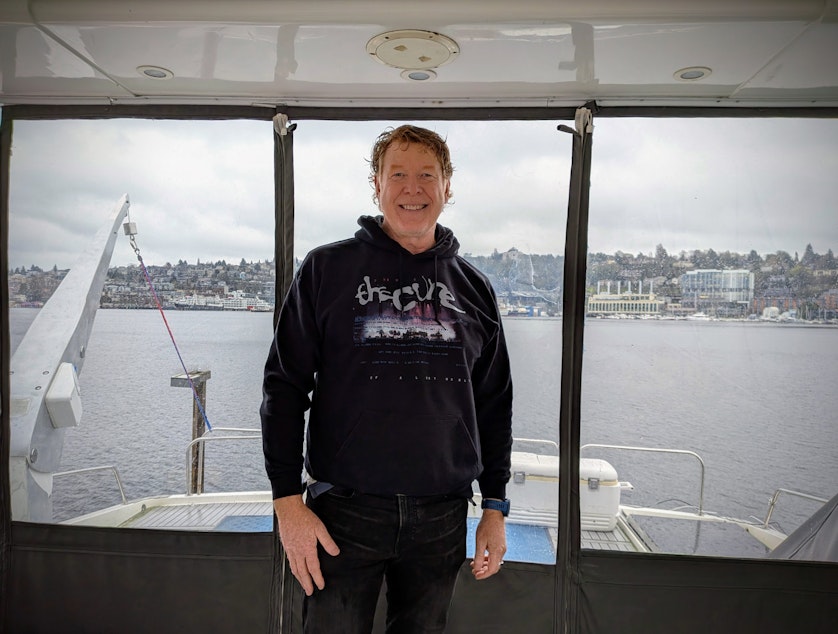 caption: Greg Holloway shows off a luxury yacht he owns and writes about for clients on Seattle's Lake Union.